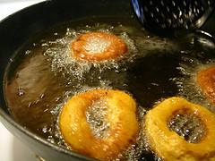 Donuts frying in vegetable oil